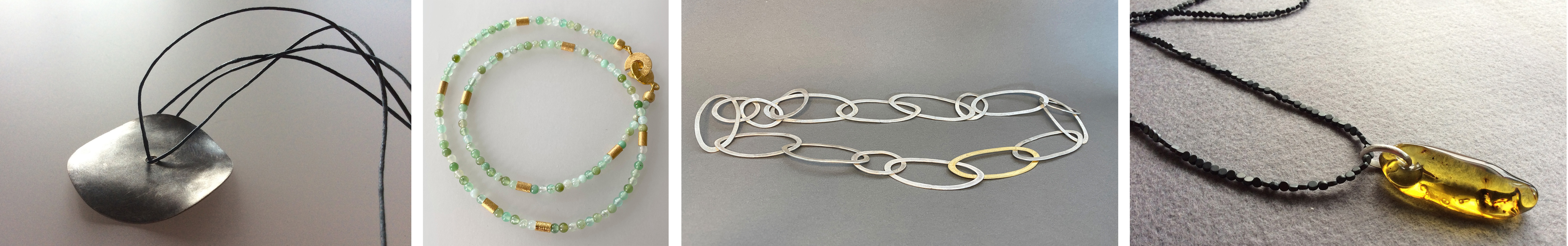 Anhänger aus einer gewellten Silberscheibe, gebürstet und oxidiert, Lederschnüre; Halskette aus kleinen Chrysokollperlen in verschiedenen Grüntönen, Silber-Elemente vergoldet;; Silberkette aus gewalzten Silberdrähten in verschiedenen ovalen Formaten, teilvergoldet; Bernstein-Anhänger mit geschmiedeter Silberöse und  einer langen Kette aus Hämatinperlen. 